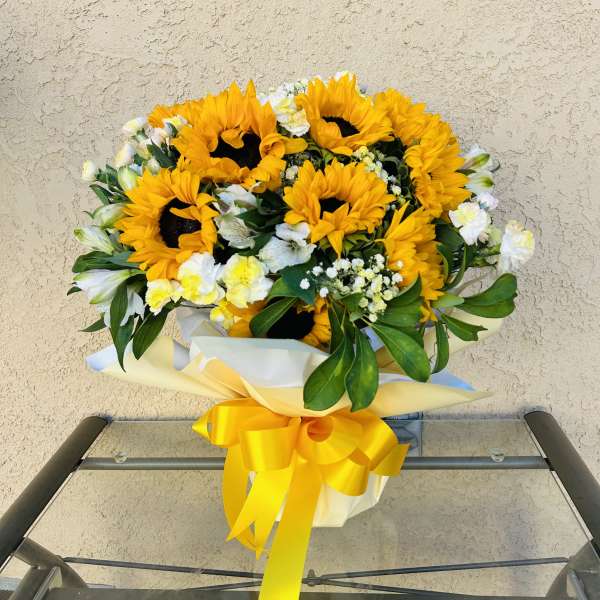 Bouquet of sunflowers with white flowers and a yellow ribbon