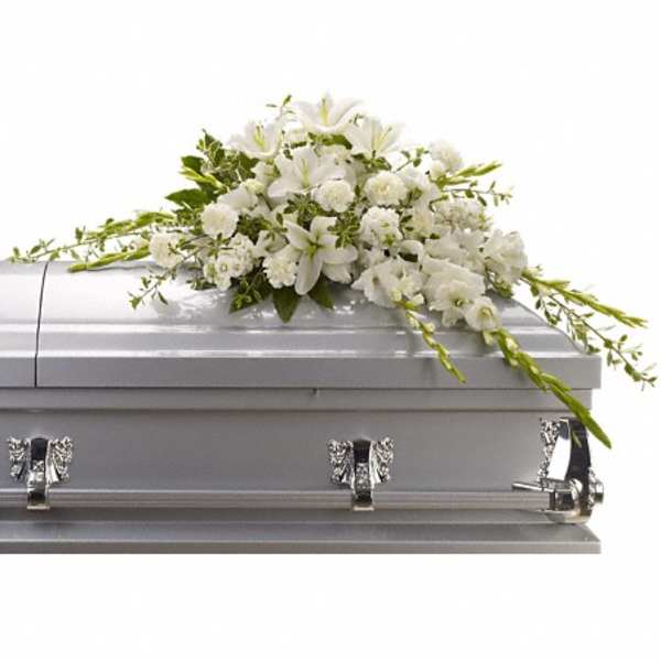 White floral spray on a silver casket