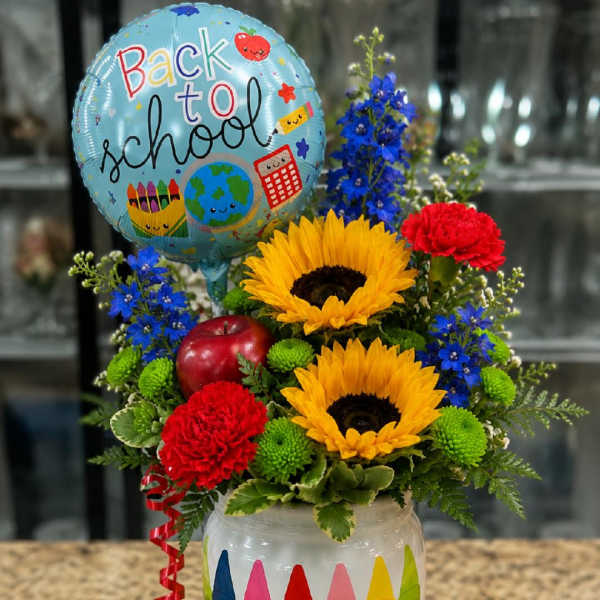 Sunflowers and carnations in a decorated jar with a back-to-school balloon