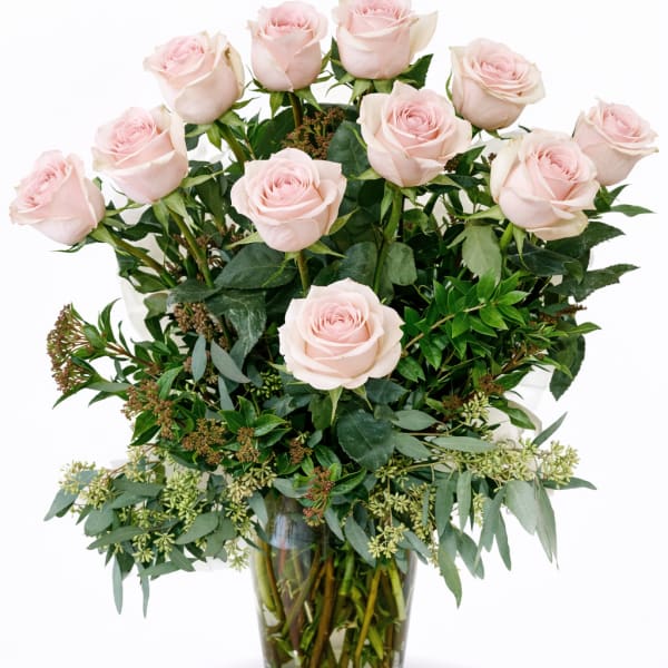 Arrangement of pale pink roses in a clear glass vase