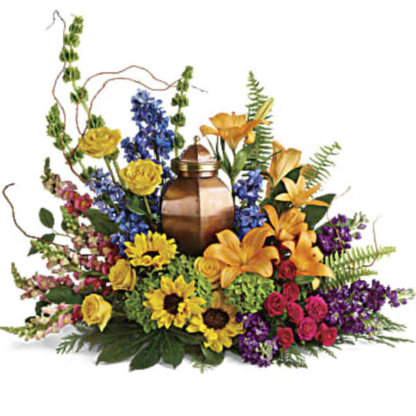 Colorful floral arrangement around a bronze urn