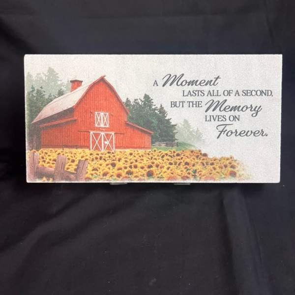 Memorial card with a red barn and a field of sunflowers