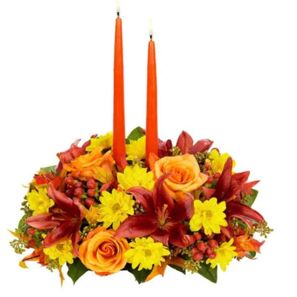Autumn floral centerpiece with two orange taper candles
