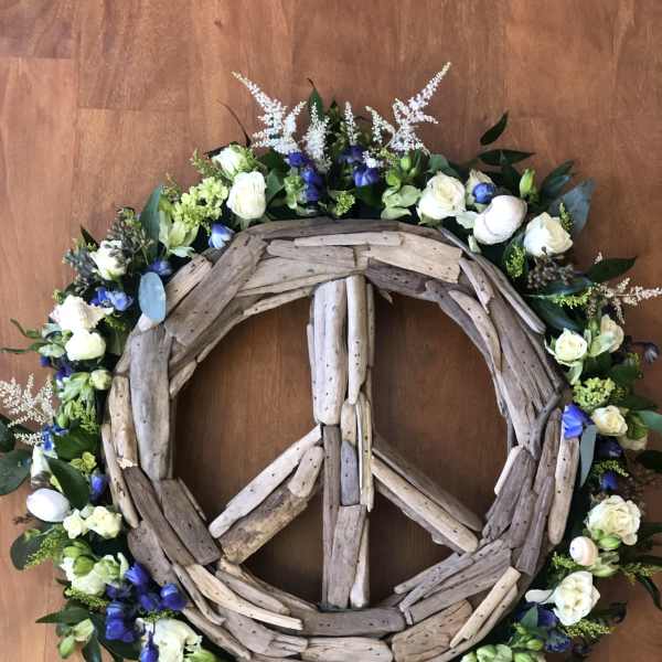 Driftwood peace sign wreath with white and blue flowers