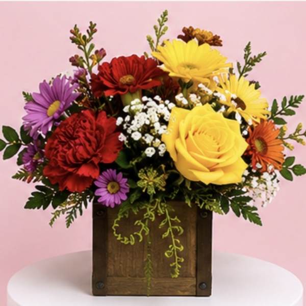 Colorful mixed flower arrangement in a wooden box