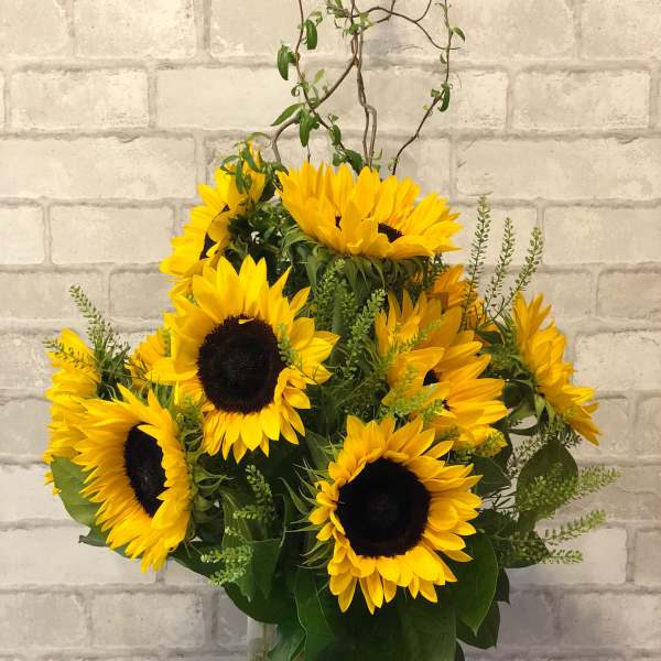 Sunflower arrangement in a clear glass vase