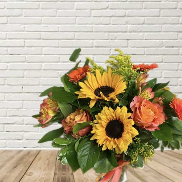 Bouquet of sunflowers and orange roses in a vase
