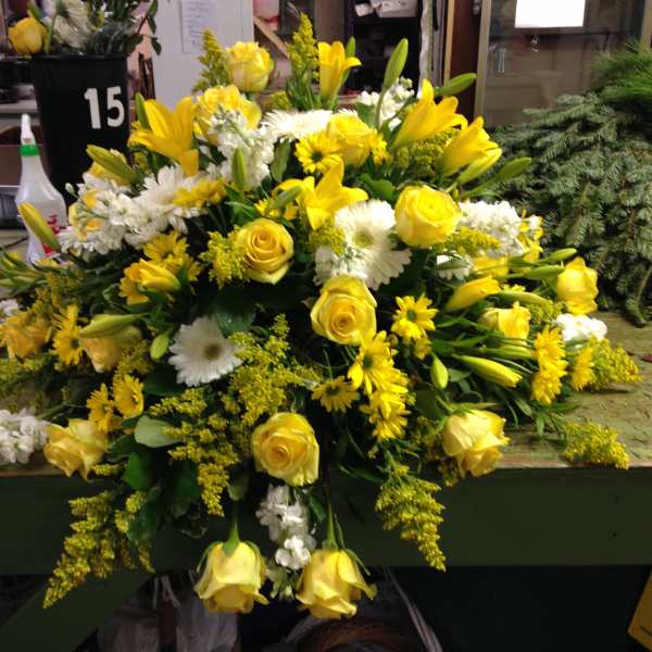Yellow and white floral arrangement with roses and lilies