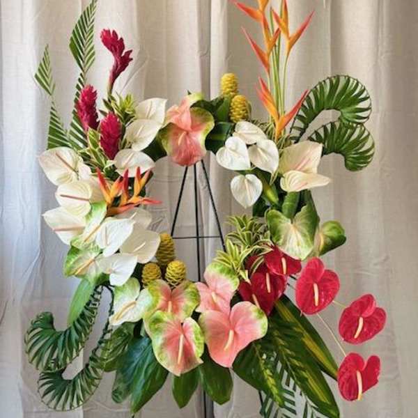 Tropical floral wreath with anthuriums and bird-of-paradise on a stand
