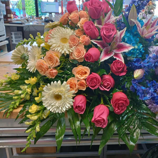 Large mixed bouquet with pink roses, white daisies, and blue flowers