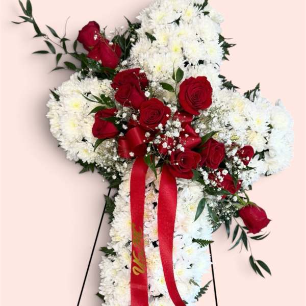 Standing floral spray of white chrysanthemums and red roses with a red ribbon