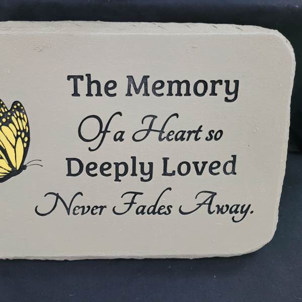 Memorial plaque with a yellow butterfly and remembrance text
