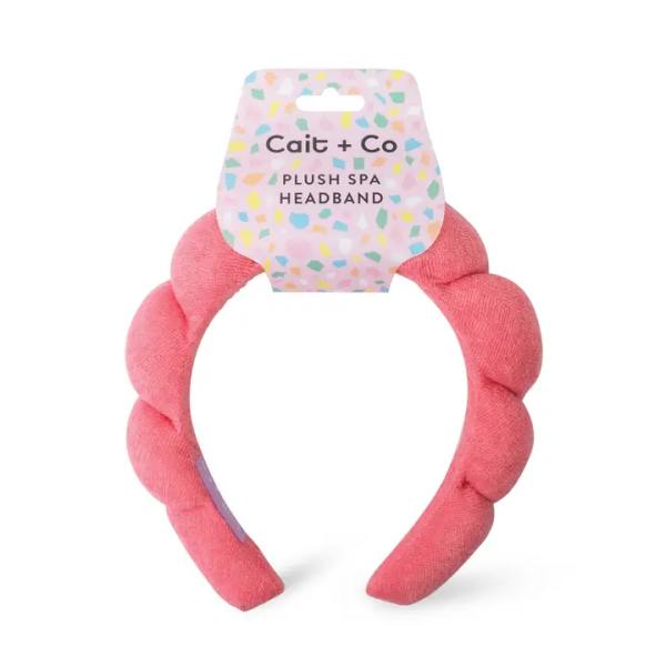 Pink plush spa headband with a packaged label