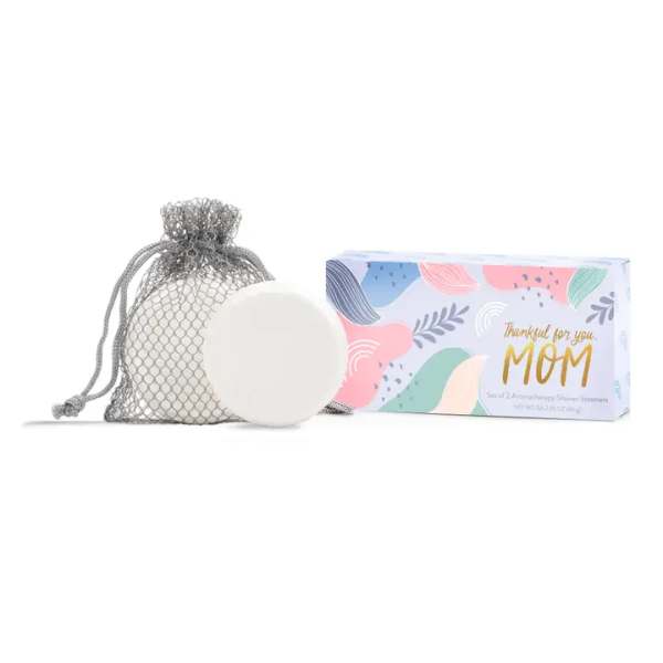 Soap bar in a mesh bag beside a pastel gift box for mom