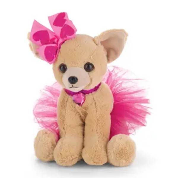 Tan teddy bear wearing a pink tutu and heart bow