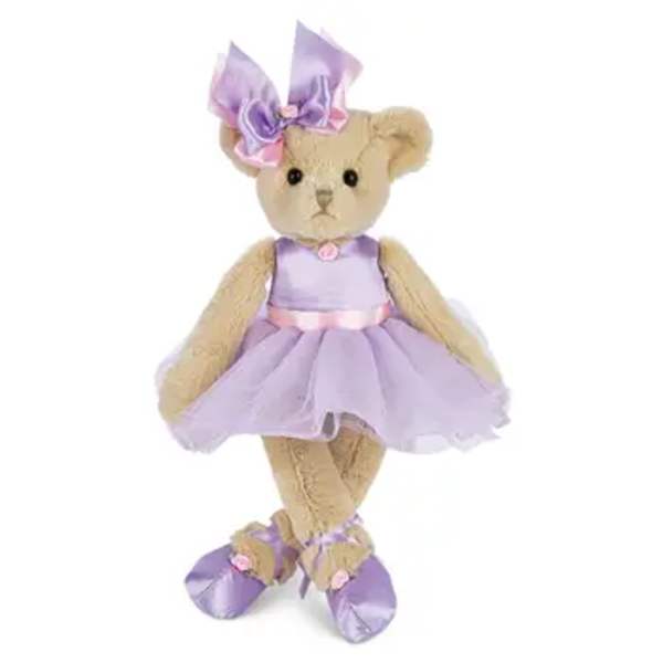 Teddy bear in a lavender dress and bow