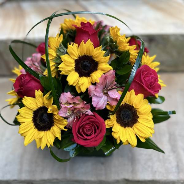 Bouquet of yellow sunflowers, pink roses, and pink alstroemeria
