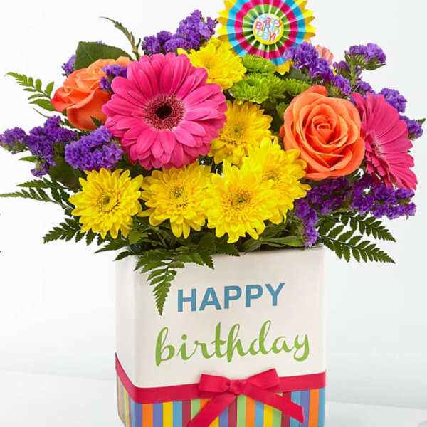 Bright mixed bouquet in a birthday gift box with a colorful topper