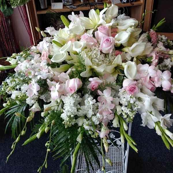 Large white and pale pink floral spray with lilies and roses