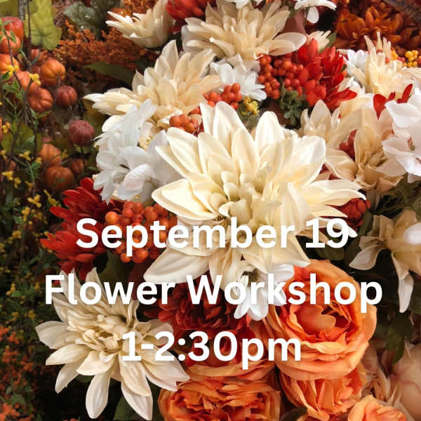 Autumn floral display with cream, orange, and red blooms and workshop text