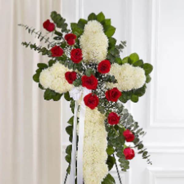 Standing floral cross with red roses and white blooms