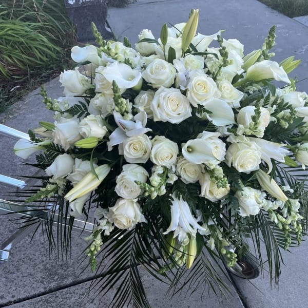 Large white floral spray with roses, lilies, and calla lilies