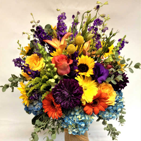 Colorful mixed bouquet in a burlap-wrapped vase