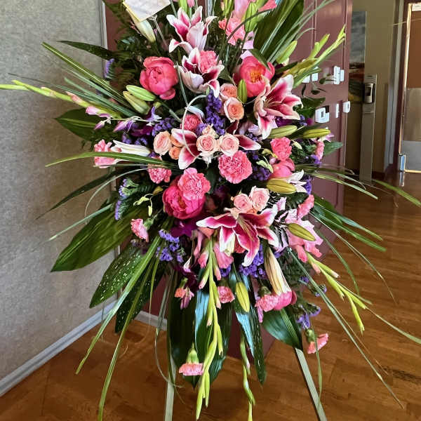 Tall pink and white floral standing arrangement with lilies and roses