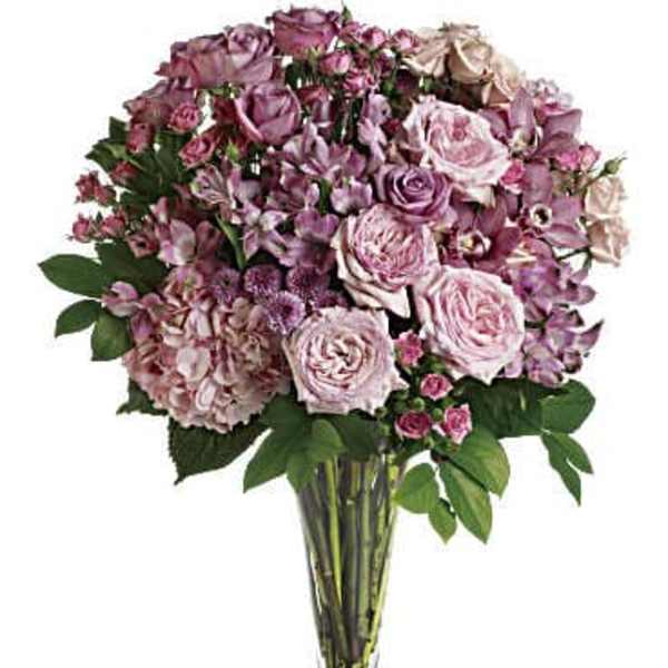 Pink and lavender rose bouquet in a clear glass vase