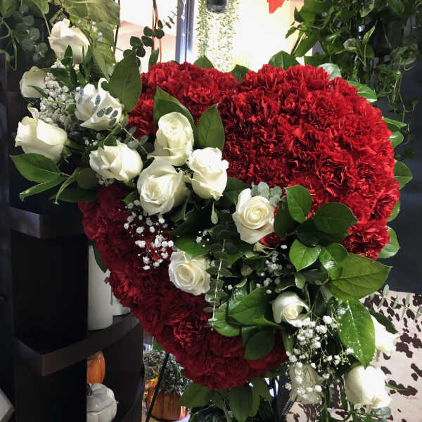 Heart-shaped red carnation arrangement with white roses