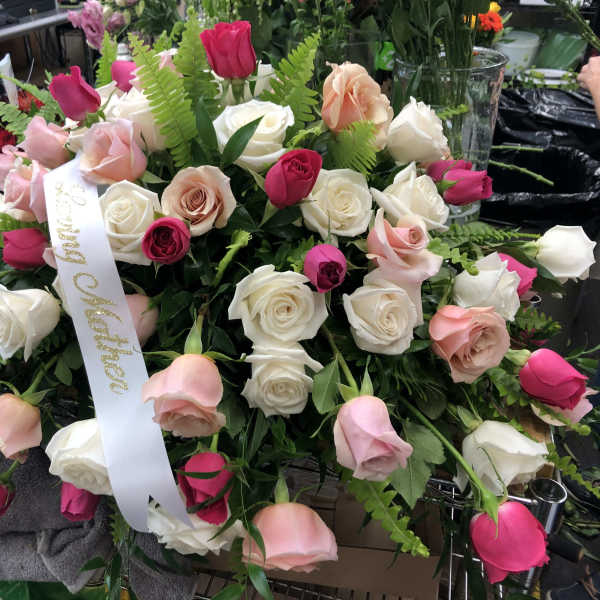 Large bouquet of pink and white roses with a ribbon