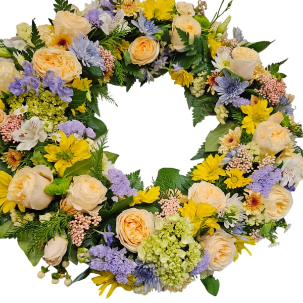 Circular floral wreath with cream roses, yellow daisies, and lavender blooms