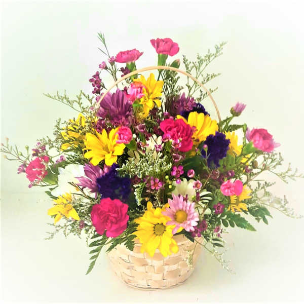 Colorful mixed bouquet in a woven basket