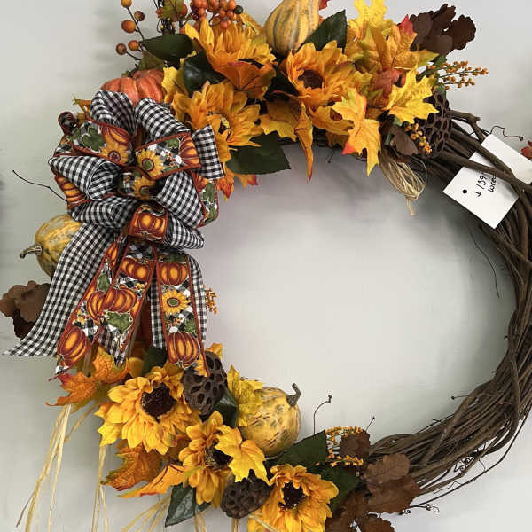 Fall wreath with sunflowers, pumpkins, and a plaid bow