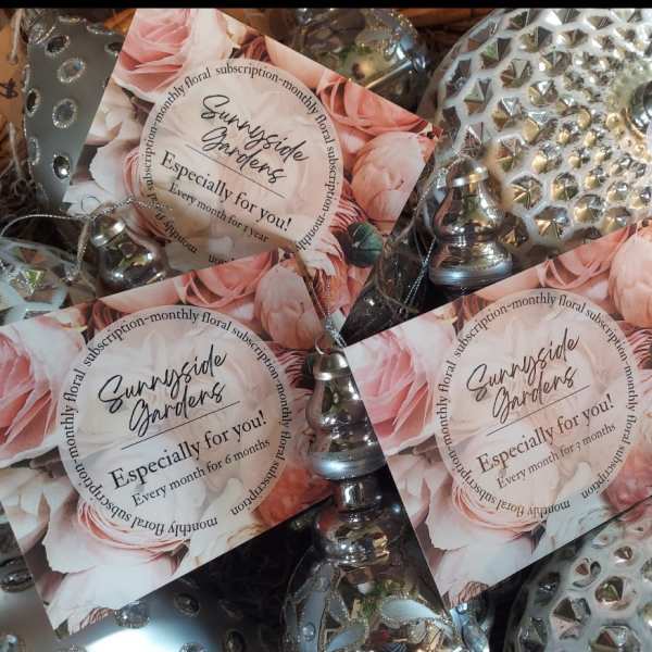 Stack of floral subscription cards with silver decorative bells