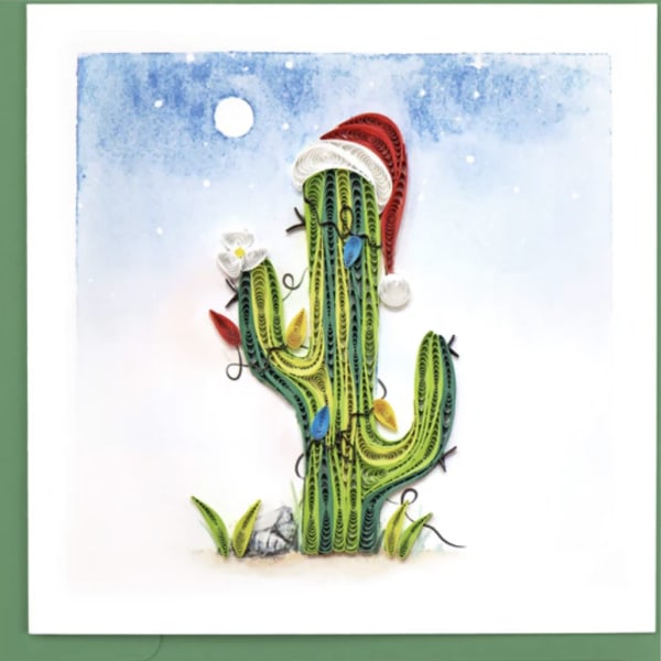 Quilled cactus artwork with a Santa hat on a snowy blue background