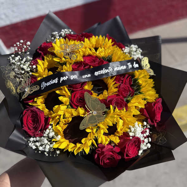 Bouquet of red roses and yellow sunflowers with butterfly accents