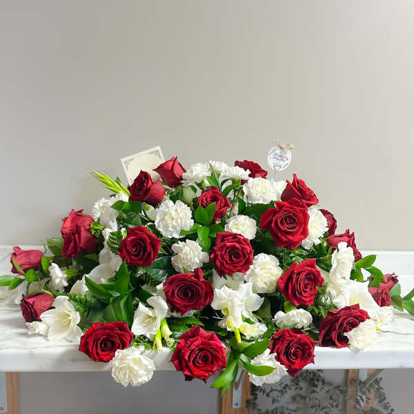 Red roses and white carnations arranged in a low mound