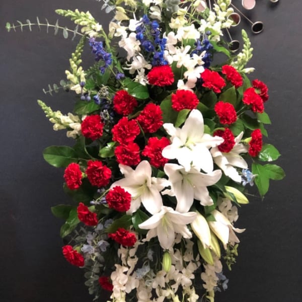 Standing floral spray with red carnations and white lilies