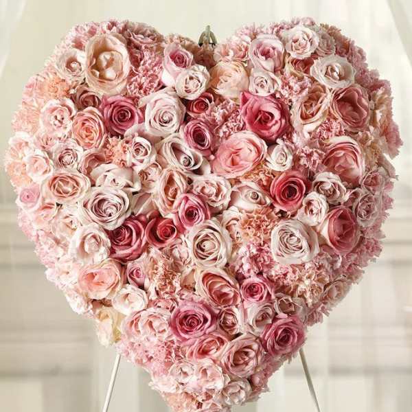 Heart-shaped arrangement of pink and blush roses