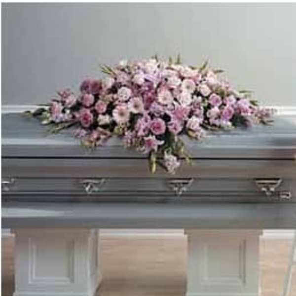 Pink floral casket spray with lilies and roses