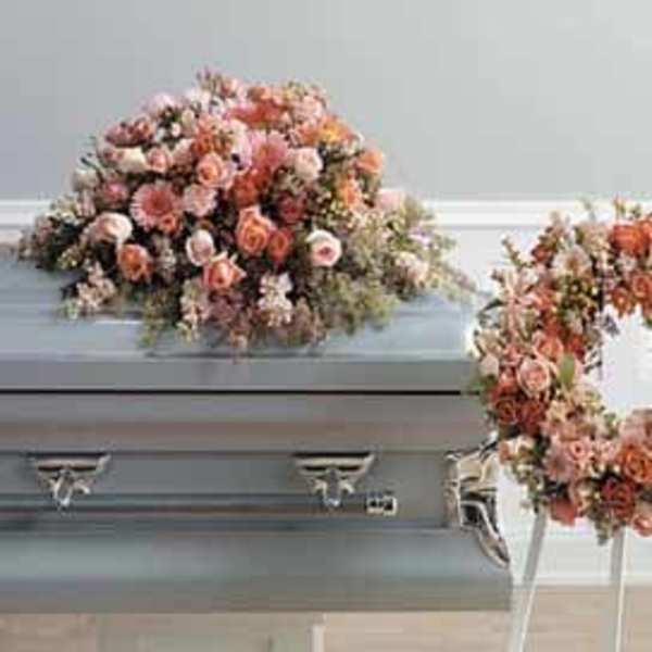 Floral casket spray and wreath in pink and peach tones