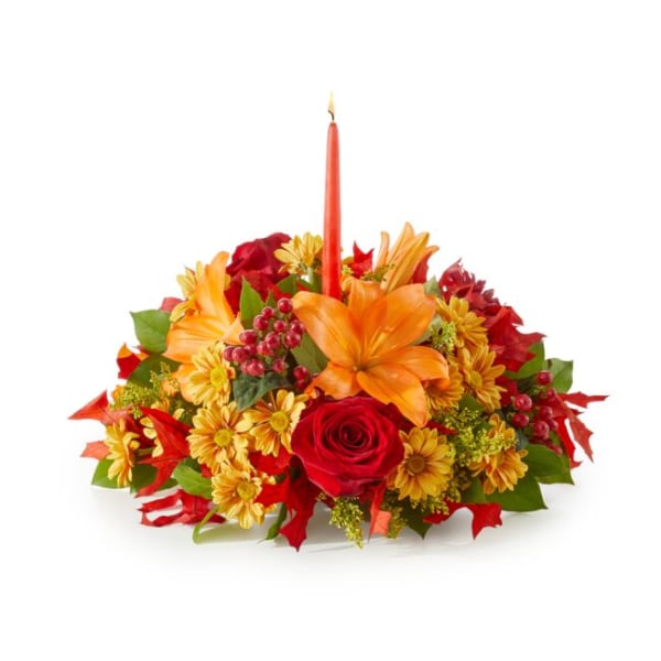 Autumn floral centerpiece with a red taper candle