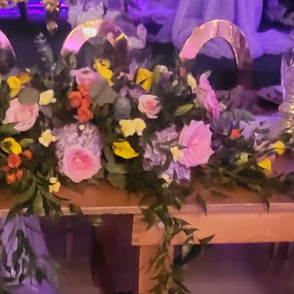 Main center piece with purple, yellow, pink flowers roses, spray rose, hydrangeas