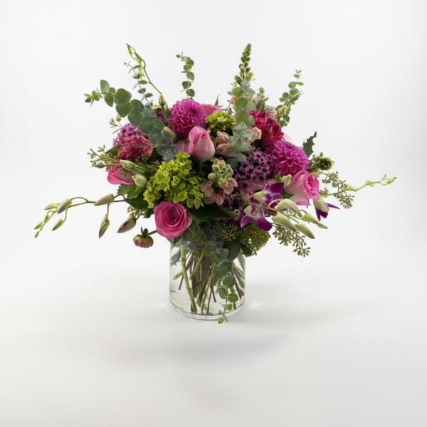 Pink and purple mixed bouquet in a clear glass vase