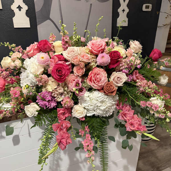 Large pink and white floral arrangement with roses and hydrangeas