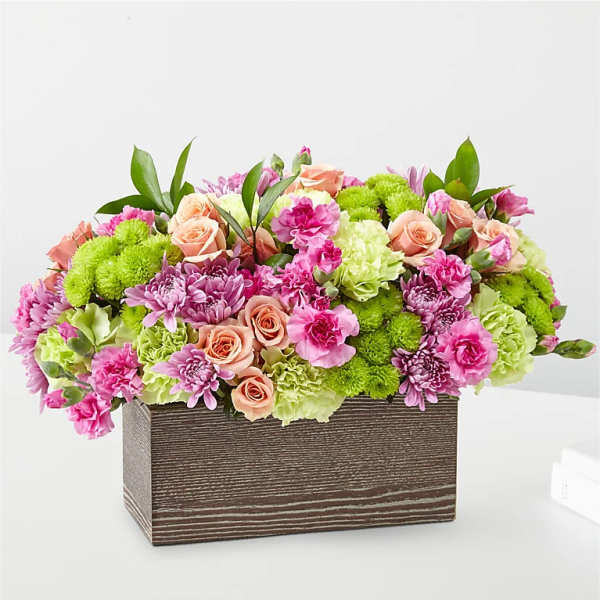 Pink and green mixed flower arrangement in a rectangular wooden box