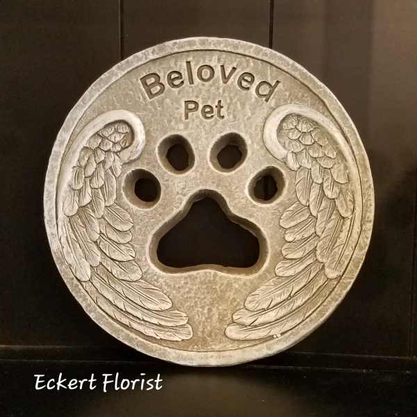 Round memorial plaque with a paw print and angel wings reading "Beloved Pet"
