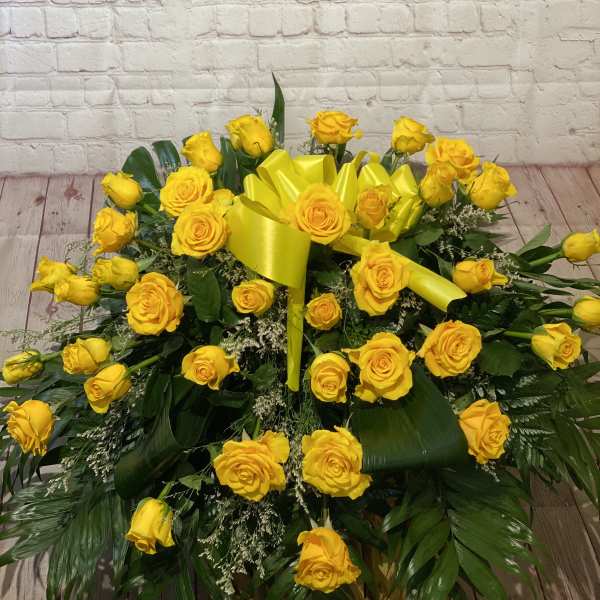 Large yellow rose arrangement with a bright yellow ribbon