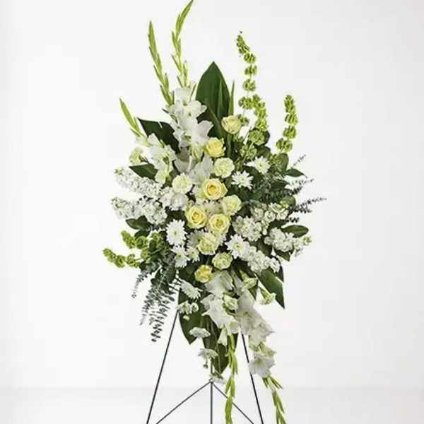 Tall white and pale green floral standing spray on an easel